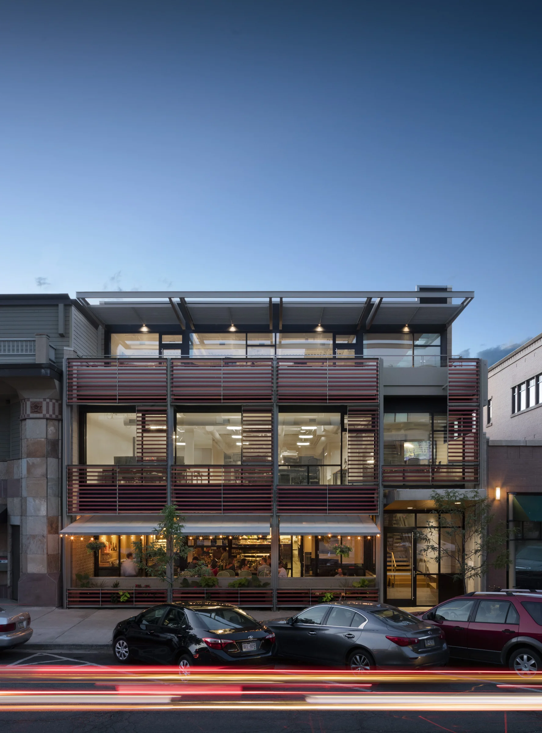 909 Walnut mixed-use facade illuminated at dusk